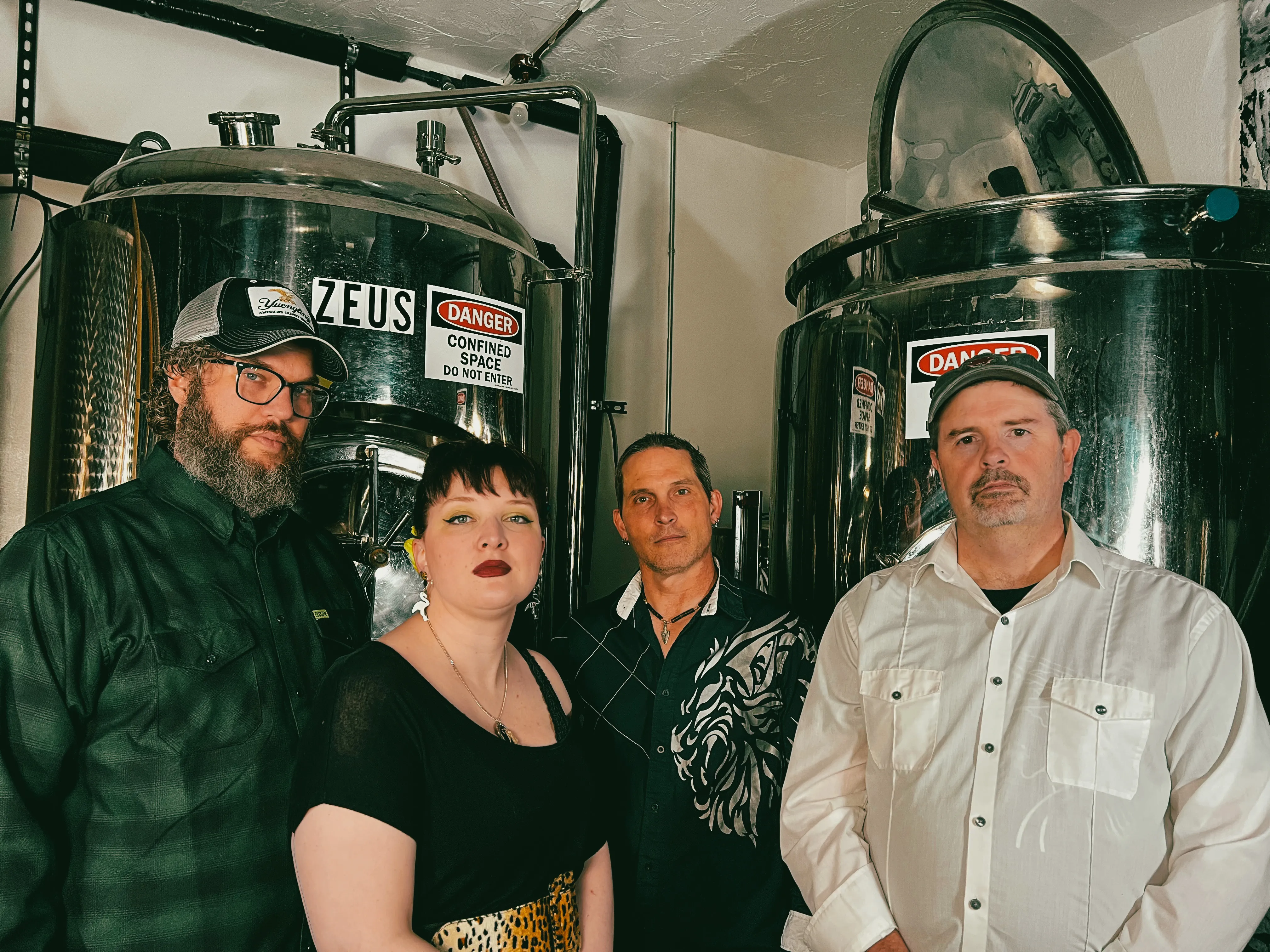 Band photo of the members of Tinker's Damn in a brewroom